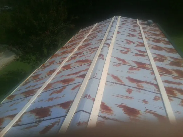 Rusted metal roof panels with new wood purlins before replacement — Storm Damage Roof Repair in Lewisport by Roofing Brothers